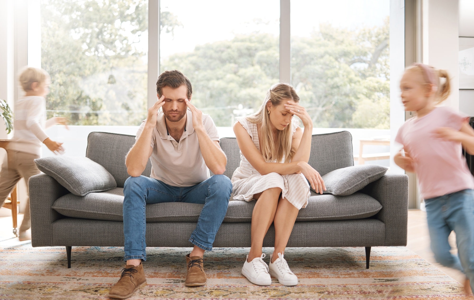 Noise, headache and stress with children and parents in a living room, overwhelmed by adhd and auti