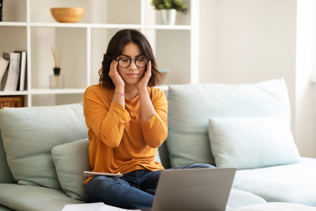 Tired Young Arab Woman Suffering Headache While Study With Laptop At Home